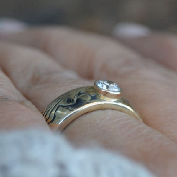 Handcrafted mokume gane engagement ring with low set full bezel stone