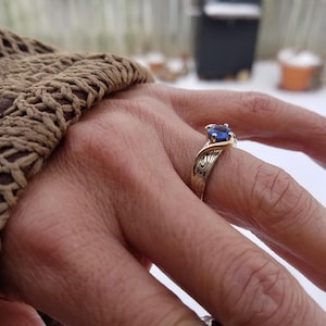 Ocean design engagement ring with montana sapphire.   Custom made engagement ring with mokume gane in white gold and yellow gold ring