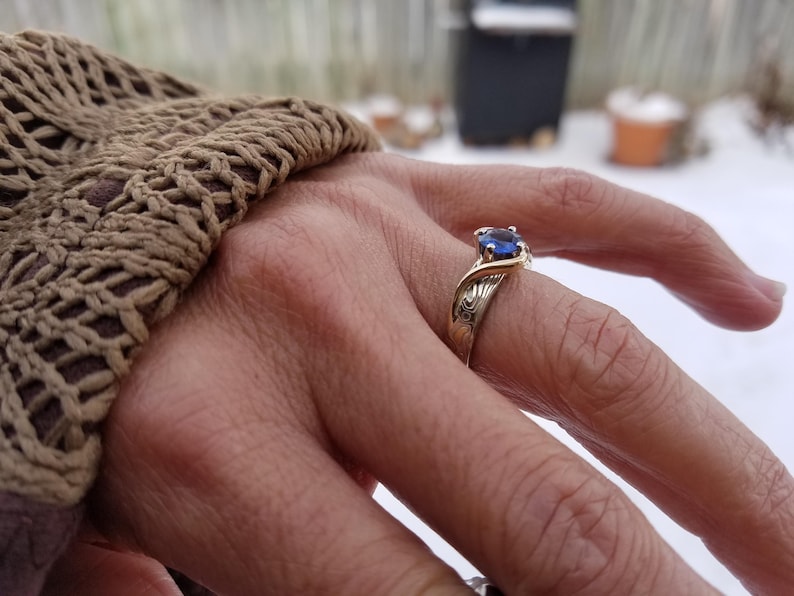 Ocean design engagement ring with montana sapphire.   Custom made engagement ring with mokume gane in white gold and yellow gold ring
