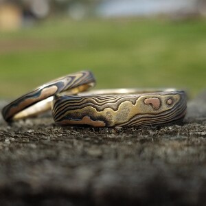 Unique matching band set of Mokume gane wedding band set from same billet tri gold and silver etched