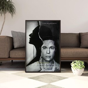 May include: A black and white film poster for The Curious Case of Benjamin Button, featuring a split-profile portrait of Brad Pitt and Cate Blanchett. The title text is centred at the bottom, with the actors' names printed at the top.