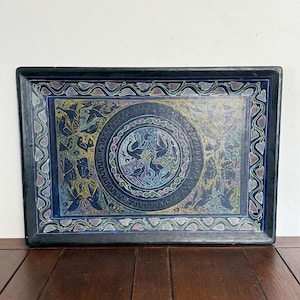 May include: Rectangular black serving tray with a detailed, colorful design. The tray features a central circular motif with birds and a surrounding border with floral and bird patterns. The artwork is in shades of blue, green, yellow, and purple.