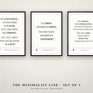 May include: A set of three framed wall art prints featuring black text on a white background. Each print displays a different Bible verse with a small cross icon at the bottom. The text includes quotes from 1 Corinthians, Proverbs, and Joshua.