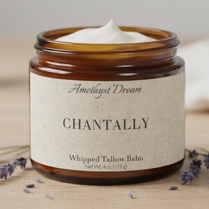 May include: A jar of "Chantally" whipped tallow balm from "Amethyst Dream" with a white creamy top. The label is beige with black text. The jar is surrounded by lavender sprigs. Net wt. 4 oz (113 g).
