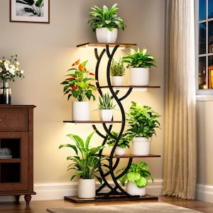 May include: A multi-tiered plant stand with a black metal frame and wooden shelves. The stand holds various potted plants with green foliage and white pots. The stand has built-in lights, creating a warm glow. The design is modern and suitable for indoor use.