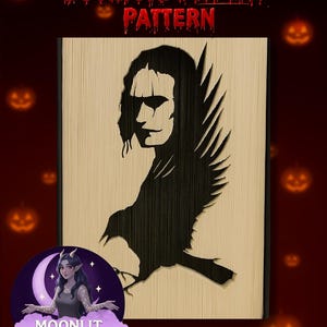 May include: A wooden bookfold display pattern with a black raven and face silhouette. The text "Bookfold DISPLAY PATTERN" is at the top. The logo for "Moonlit Munchkin Creations" is at the bottom. The background is dark red with pumpkin graphics.