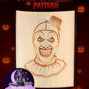 May include: A bookfold display pattern featuring a carved image of a scary clown face. The text "Bookfold DISPLAY PATTERN" is in red at the top. The image is set against a dark red background with Halloween-themed accents.