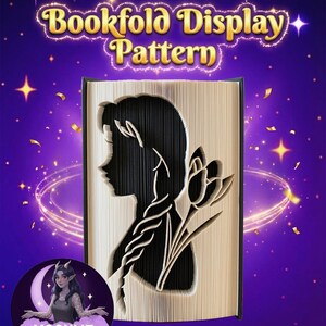 May include: A bookfold display pattern with a silhouette of a woman and a flower cut into the pages. The text "Bookfold Display Pattern" is in gold lettering. The background is purple with stars and a crescent moon with a woman.