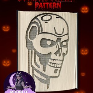 May include: A bookfold display pattern featuring a skull design cut into the pages. The text "Bookfold DISPLAY PATTERN" is displayed in red at the top. The image has a dark red background with jack-o'-lanterns.