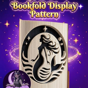 May include: A bookfold display pattern featuring a mermaid silhouette. The design is cut into the pages of a book, with the text "Bookfold Display Pattern" at the top. The background is purple with stars and a crescent moon.