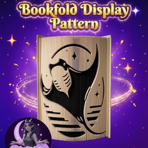 May include: A bookfold display pattern with a manta ray design cut into the pages. The text "Bookfold Display Pattern" is in gold lettering. The background is purple with stars and a crescent moon graphic.