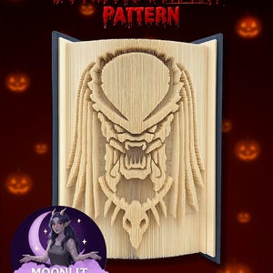 May include: A bookfold display pattern showcasing a Predator's face, crafted from folded book pages. The text "Bookfold DISPLAY PATTERN" is in red. The background is dark red with Halloween-themed jack-o'-lanterns. The book is open, revealing the intricate design.