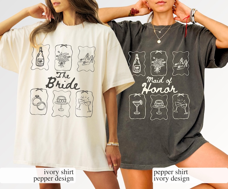 May include: Two oversized t-shirts, one ivory and one pepper-coloured, with wedding-themed graphics. The ivory shirt reads "The Bride", the pepper shirt says "Maid of Honor". Each shirt has six illustrated icons.