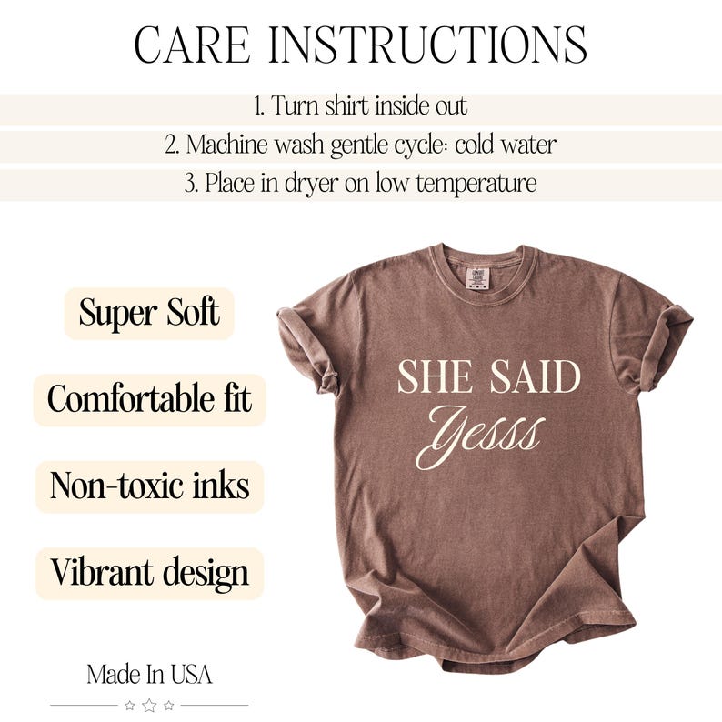 May include: A brown t-shirt with the text "SHE SAID Yesss" in a cursive font. The shirt has rolled-up sleeves and is displayed on a white background. Additional text includes "Super Soft", "Comfortable fit", "Non-toxic inks", and "Vibrant design".