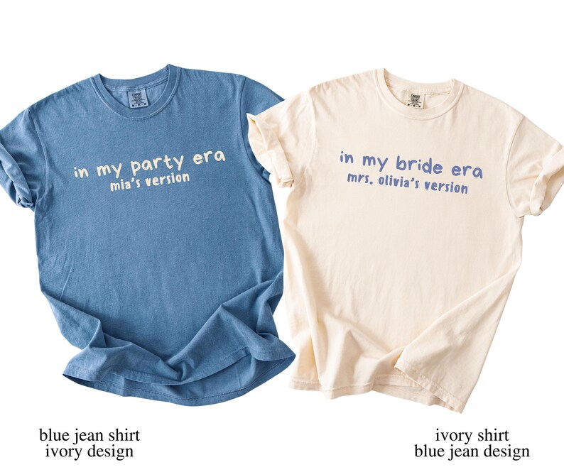 May include: Two t-shirts, one blue and one ivory, with text. The blue shirt says "in my party era mia's version" in white. The ivory shirt says "in my bride era mrs. olivia's version" in blue. Both shirts are short-sleeved.