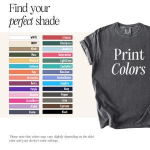May include: A dark gray t-shirt with the words "Print Colors" in white. The image also displays a color chart with various shades, including white, ivory, khaki, moss, and crimson.