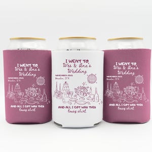 May include: Three can coolers with a wedding theme. Two are a deep magenta color, and one is white. Each cooler has the text "I went to Wes & Ana's Wedding" and "And all I got was this lousy shirt."