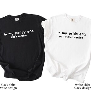 May include: Two t-shirts, one black and one white. The black shirt has the text "in my party era mia's version" in white. The white shirt has the text "in my bride era mrs. olivia's version" in black. Both shirts are short-sleeved.