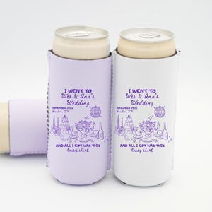 May include: Two slim can coolers, one lavender and one white, each holding a can. The coolers feature a wedding-themed design with text that reads "I went to Wes & Ana's Wedding" and "And all I got was this lousy shirt."