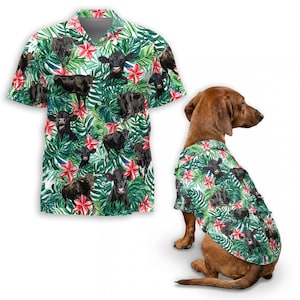May include: A short-sleeved button-down shirt and a dog shirt featuring a tropical pattern with black cows, red flowers, and green leaves on a white background. The dog shirt is on a brown dachshund.