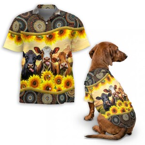 May include: A short-sleeved shirt and a dog shirt featuring a sunflower and cow design. The shirts have a yellow background with sunflowers and a pattern of brown and gold circles. The cow graphic has three cows with their tongues out.