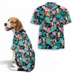 May include: A short-sleeved button-down shirt and a dog wearing a matching shirt. Both shirts feature a pattern of brown and white cows, pink flowers, and teal leaves on a black background. The dog is a beagle.