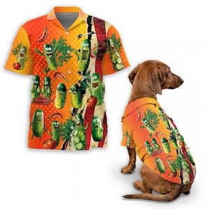 May include: Orange and yellow short-sleeve button-down shirt with a pickle pattern. The shirt features cartoon pickles, tomatoes, and chili peppers. A matching shirt is on a brown dachshund dog.