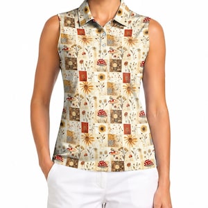 May include: A sleeveless polo shirt featuring a cream-coloured base with a repeating grid pattern. The design includes illustrations of red mushrooms with white spots, yellow sunflowers, and various wildflowers in shades of brown and orange.