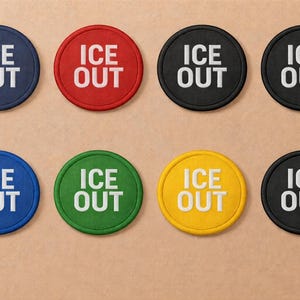 May include: Eight circular patches in various colours, including navy, red, black, blue, green, and yellow. Each patch features the white text "ICE OUT" in a bold, sans-serif font, centred on the patch.