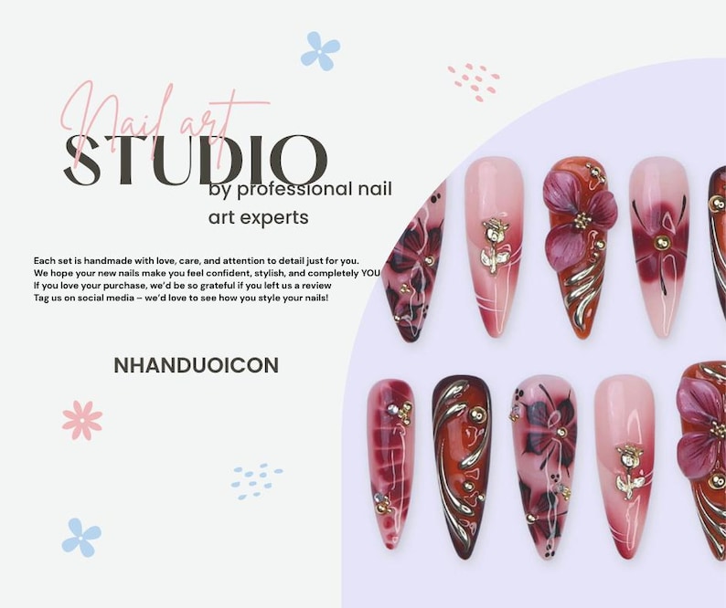 May include: A collection of artificial nails with various designs, including floral accents and jewel embellishments. The nails feature a gradient of pink and red hues, with some showcasing intricate patterns. The image also includes the text "Nail art STUDIO by professional nail art experts."