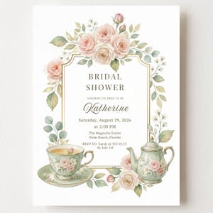 Può includere: Un invito per un bridal shower con una cornice dorata circondata da rose rosa e foglie verdi ad acquerello. Include una tazza da tè su un piattino e una teiera, con il testo: BRIDAL SHOWER, Honoring the bride-to-be Katherine, Saturday, August 29, 2026, at 2:00 PM, The Magnolia Estate, Palm Beach, Florida, RSVP TO Sarah at 555-0123 by July 1st.