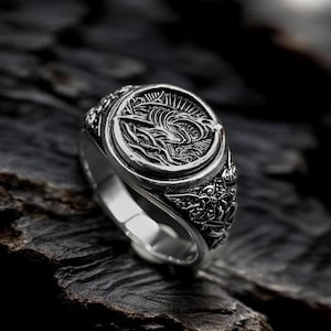 May include: A white ceramic mug with a black handle and the text "But First, Coffee" in a handwritten style. The mug is on a white surface. The mug is approximately 4 inches tall.