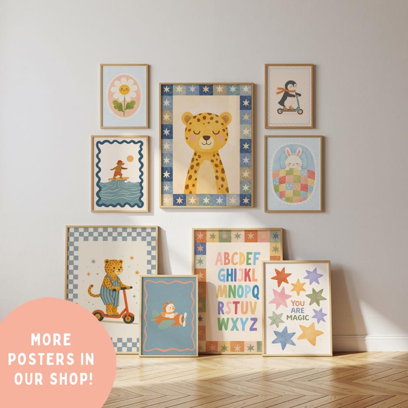 May include: A collection of framed art prints featuring whimsical illustrations. The prints include a cheetah, penguin, bunny, and flower, along with an alphabet chart and a print with the text "YOU ARE MAGIC". The prints are in various sizes and colors.
