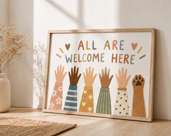 May include: A framed horizontal print featuring the text ALL ARE WELCOME HERE in multicolored letters. Below the text are six raised arms with diverse skin tones wearing patterned sleeves, ending with a brown animal paw print.