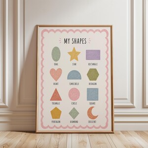 May include: A framed educational poster with the text "MY SHAPES" and illustrations of various shapes in pastel colors. Shapes include an oval, star, heart, triangle, circle, pentagon, rectangle, semicircle, hexagon, square, diamond, and crescent.