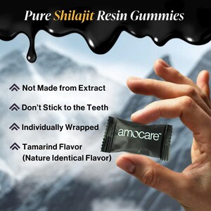 May include: Image of a hand holding a small, black amocare&trade; wrapper containing a Shilajit Resin Gummy. The wrapper is rectangular and has the brand name printed in white. The background features text that reads "Pure Shilajit Resin Gummies."