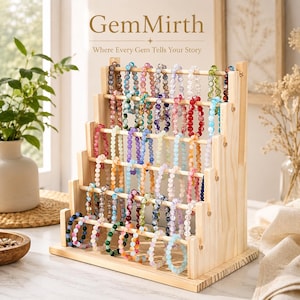 May include: A wooden bracelet display stand filled with colorful beaded bracelets. The stand has multiple tiers, showcasing bracelets in various colors like red, blue, green, and purple. The GemMirth logo is visible at the top.
