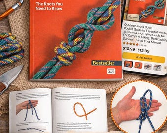 May include: An orange book titled "BACKPACKER Outdoor Knots" with a colorful rope knot on the cover. The book is open to show knot-tying instructions. A smartphone displays the book's listing. A knife and carabiners are also visible.