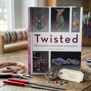 May include: A book titled "Twisted" by Nadja Shields, showcasing wire jewelry techniques and projects. The cover features images of intricate wire pendants. Tools and materials, including wire, pliers, and files, are arranged on a wooden surface.