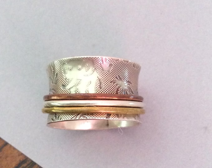 Sterling silver spinner ring with brass, copper, and silver spinners