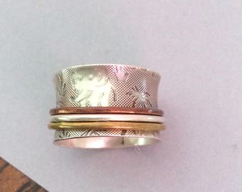 Sterling silver spinner ring with brass, copper, and silver spinners