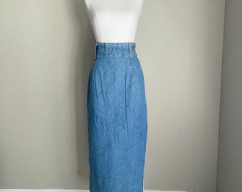 May include: A light blue denim skirt displayed on a mannequin. The skirt is a midi length with a high waist and a button and zipper closure. The skirt has a classic, timeless design.