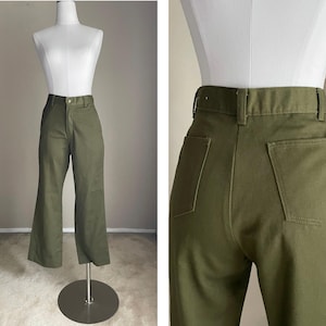 May include: A pair of green wide-leg trousers with a high waist and a straight leg.