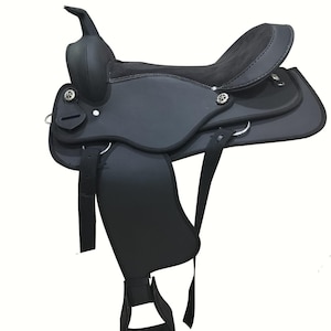 May include: A black Western saddle with a high cantle and horn. The saddle features a suede seat and leather skirts, stirrups, and fenders. Silver-colored conchos and D-rings are visible. The saddle is designed for horseback riding.