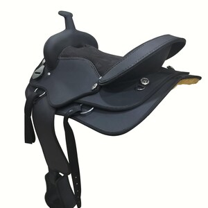 May include: A black western saddle with a high cantle and horn. The saddle features a padded seat, stirrups, and various straps and buckles. The leather appears to be in good condition, and the saddle is designed for riding horses.