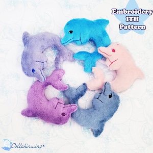 May include: Five plush dolphin toys in different colours, including blue, pink, and purple. The dolphins are arranged in a circle and are all facing inwards. The text "Embroidery ITH Pattern" is visible in the top right corner of the image.