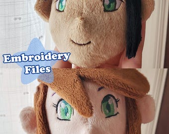 May include: Two plush toy heads with embroidered faces. The top head has black hair and brown skin. The bottom head has brown hair and light skin. Both heads have green eyes and a smiling mouth. The text "Embroidery Files" is visible in the image.