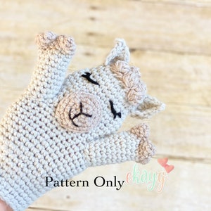 May include: A crocheted llama puppet with a white body, brown eyes, and a pink nose. The puppet is designed to fit on a hand and has a long neck and floppy ears. The text "Pattern Only" is visible in the image.