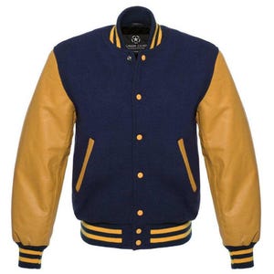May include: A navy blue varsity jacket with tan leather sleeves. The jacket has yellow detailing on the collar, cuffs, and waistband. It features a button-up front and two front pockets. The brand name "SAIDA GEAR" is visible on the collar.