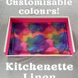 May include: A pink and white kitchenette liner with a vibrant tie-dye design. The liner is contained within a pink-edged box. Text on the image reads "Customisable colours!" and "Kitchenette Liner". The Piggy Patch logo is visible.